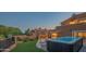 Relaxing backyard with a modern hot tub, an artificial lawn, and desert landscaping at 11025 N 10Th St, Phoenix, AZ 85020