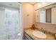 Well-lit bathroom with a granite vanity top and a shower with a decorative patterned curtain at 11025 N 10Th St, Phoenix, AZ 85020