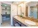 Bathroom featuring double sinks, granite countertops, a spacious walk-in closet, and gold fixtures at 11025 N 10Th St, Phoenix, AZ 85020