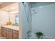 Traditional bathroom with a shower featuring tile surround, a marble vanity and a decorative 