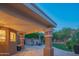 Inviting covered patio features plush green lawn and a spa, great for outdoor relaxation at 11025 N 10Th St, Phoenix, AZ 85020