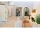 Bright entryway with tiled floors, curved arches, and views of the staircase and an alcove with a fireplace at 11025 N 10Th St, Phoenix, AZ 85020