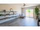 Inviting living room featuring wood-look floors, floating shelves, stylish seating and a sliding glass door at 11025 N 10Th St, Phoenix, AZ 85020