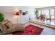 Nicely decorated living room area with decorative chair, red rug, and sight into dining area at 11025 N 10Th St, Phoenix, AZ 85020
