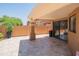 Covered patio with travertine flooring, desert landscaping, and sliding glass doors at 11025 N 10Th St, Phoenix, AZ 85020
