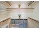Organized walk-in closet features custom shelving, wooden rods and gray storage boxes for efficient storage at 11025 N 10Th St, Phoenix, AZ 85020