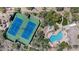 Aerial view of blue tennis courts and a uniquely shaped pool at this community clubhouse at 11081 E Betony Dr, Scottsdale, AZ 85255