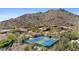 Scenic aerial view of tennis courts nestled within a desert landscape community at 11081 E Betony Dr, Scottsdale, AZ 85255