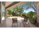 Relaxing back patio with chairs, end table, manicured garden, and shaded cover from the sun's rays at 11081 E Betony Dr, Scottsdale, AZ 85255