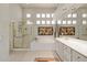 Bright bathroom featuring a glass-enclosed shower, soaking tub, and double vanity with bright lighting at 11081 E Betony Dr, Scottsdale, AZ 85255