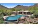Gorgeous community pool with shaded seating area and majestic mountain views at 11081 E Betony Dr, Scottsdale, AZ 85255