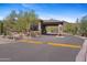 View of the community entrance gate featuring stone accents, desert landscaping, and a secure entry point at 11081 E Betony Dr, Scottsdale, AZ 85255