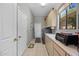 Well-lit laundry room with ample storage cabinets, washer, dryer, and access to the outside at 11081 E Betony Dr, Scottsdale, AZ 85255