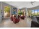Inviting living room featuring a fireplace, comfortable seating, and outdoor views from multiple windows at 11081 E Betony Dr, Scottsdale, AZ 85255