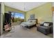 Bright main bedroom with a ceiling fan, and a scenic view out the large windows at 11081 E Betony Dr, Scottsdale, AZ 85255