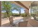 Covered patio with outdoor seating surrounded by desert landscaping and a scenic view at 11081 E Betony Dr, Scottsdale, AZ 85255