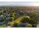 Tranquil suburban neighborhood with a central green space and mountain views in the distance at 11866 N 143Rd Ave, Surprise, AZ 85379