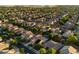 Residential neighborhood with mature trees, single Gathering homes, and solar panels on many rooftops at 11866 N 143Rd Ave, Surprise, AZ 85379