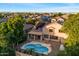 Beautiful home with a private backyard pool, covered patio, desert landscaping, and solar panels at 11866 N 143Rd Ave, Surprise, AZ 85379