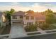 Aerial view of a two-story home with solar panels, manicured lawn, and a two car garage with mountain views at 11866 N 143Rd Ave, Surprise, AZ 85379