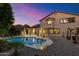 Relaxing backyard with pool, patio, and desert landscaping for comfortable outdoor living and entertaining at 11866 N 143Rd Ave, Surprise, AZ 85379