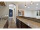 Stylish bar area with granite countertops and dark wood cabinets at 11866 N 143Rd Ave, Surprise, AZ 85379