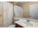 Cozy bathroom with a sink and a shower with a shower curtain with flower print at 11866 N 143Rd Ave, Surprise, AZ 85379