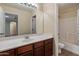 Well-lit bathroom with a single vanity and a shower and tub combo at 11866 N 143Rd Ave, Surprise, AZ 85379