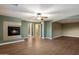 Open living room features a cozy fireplace and hardwood floors with natural light enhancing the space at 11866 N 143Rd Ave, Surprise, AZ 85379