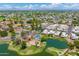 Picturesque aerial view showing community pool, lake, and lush green landscape surrounded by well-maintained residences at 1338 E Greenway Cir, Mesa, AZ 85203