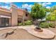 Spacious backyard featuring a decorative fountain, fire pit, and lush landscaping at 1338 E Greenway Cir, Mesa, AZ 85203