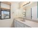 Bright bathroom with vanity, large mirror, and natural light from the window for a refreshing space at 1338 E Greenway Cir, Mesa, AZ 85203