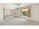 Comfortable bedroom with mirrored closet doors, ceiling fan, and window with natural light at 1338 E Greenway Cir, Mesa, AZ 85203