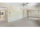 Large bedroom featuring mirrored closet doors, ceiling fan and neutral colored carpet and walls at 1338 E Greenway Cir, Mesa, AZ 85203