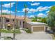 Charming two-story home featuring a clay tile roof, desert landscaping, and a two-car garage at 1338 E Greenway Cir, Mesa, AZ 85203