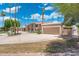 Expansive estate featuring a circular driveway and lush landscaping, creating a grand entrance at 1338 E Greenway Cir, Mesa, AZ 85203