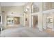Open-concept living space with vaulted ceilings, staircase, and tiled flooring accents at 1338 E Greenway Cir, Mesa, AZ 85203