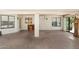 Well-lit sun room featuring flagstone flooring, large windows, and access to the backyard at 1338 E Greenway Cir, Mesa, AZ 85203