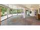 Bright sun room with large windows, glass block accents, and unique stone flooring at 1338 E Greenway Cir, Mesa, AZ 85203