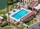 Inviting aerial view of a community pool and pool-side seating, surrounded by lush landscaping at 1338 E Greenway Cir, Mesa, AZ 85203