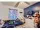 Cozy bedroom with blue accent wall, carpet floors and lots of decor at 13802 N 37Th Dr, Phoenix, AZ 85053