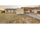Charming single-story home featuring a carport, desert landscaping, and solar panels for energy efficiency at 13802 N 37Th Dr, Phoenix, AZ 85053