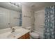 Well-lit bathroom features a wood vanity, large mirror, and tub with shower, offering convenience and functionality at 1402 E Guadalupe Rd # 122, Tempe, AZ 85283