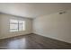 Bright bedroom featuring stylish wood-look floors and a large window with natural light at 1402 E Guadalupe Rd # 122, Tempe, AZ 85283