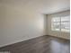 A well-lit bedroom featuring stylish wood-look floors and a window, creating a comfortable space at 1402 E Guadalupe Rd # 122, Tempe, AZ 85283