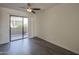 Primary bedroom features wood floors, neutral walls, and a sliding glass door to the balcony at 1402 E Guadalupe Rd # 122, Tempe, AZ 85283
