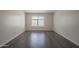 Bedroom showcasing a large window offering natural light, modern flooring, and ample open space at 1402 E Guadalupe Rd # 122, Tempe, AZ 85283