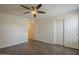 This bright bedroom features modern wood floors, a ceiling fan, and a closet with sliding doors at 1402 E Guadalupe Rd # 122, Tempe, AZ 85283