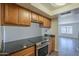 This kitchen features stone countertops, wood cabinets and stainless steel appliances at 1402 E Guadalupe Rd # 122, Tempe, AZ 85283