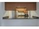 An open kitchen features granite counters and wood cabinetry at 1402 E Guadalupe Rd # 122, Tempe, AZ 85283